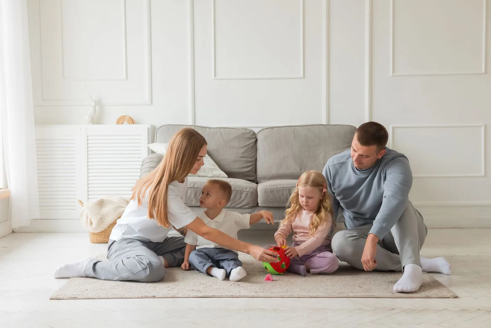 A family building and playing together in their living room