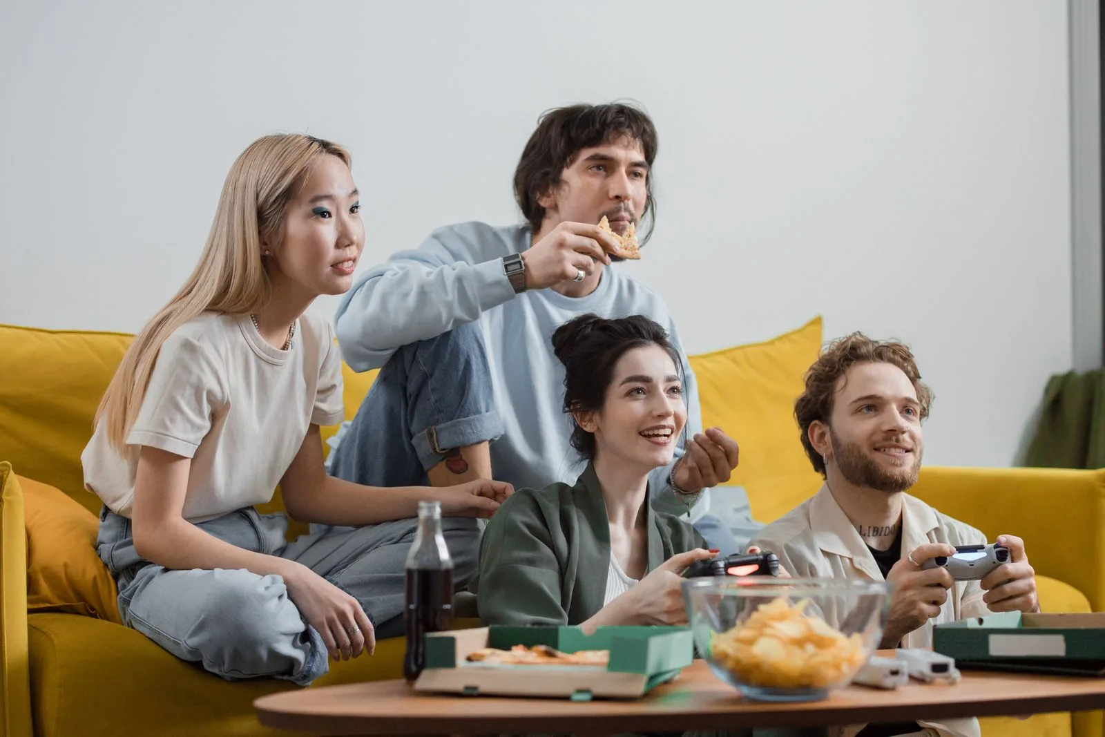 A group of friends playing games together on a couch