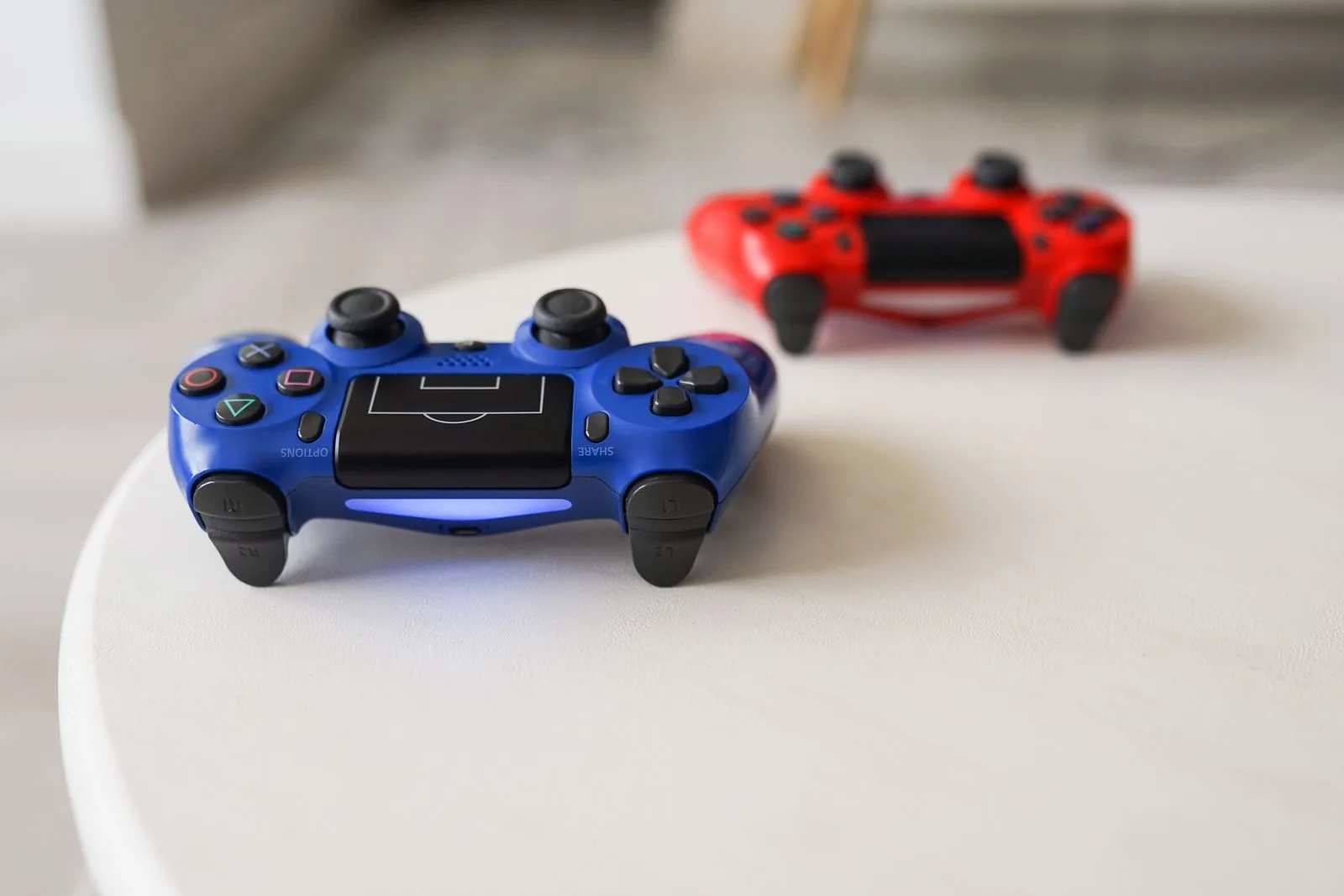 Multiple game controllers for different consoles laid out on a table