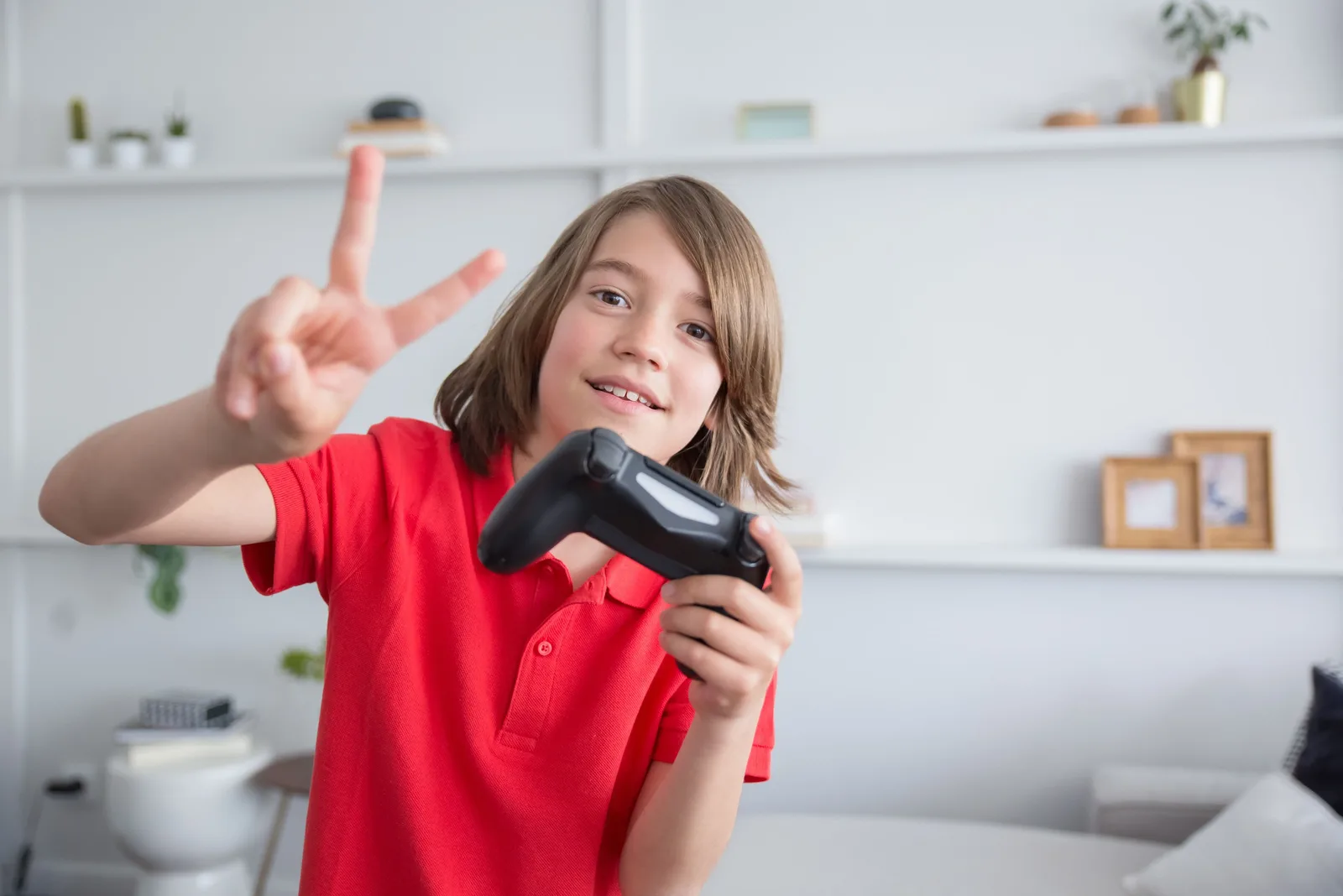 A child playing a video game with a controller, smiling